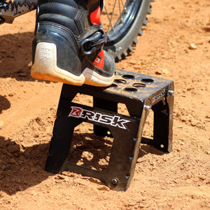 Extreme Close up of an Adjustable Motocross Starting Block with just the motocross riders boot in view sitting on top