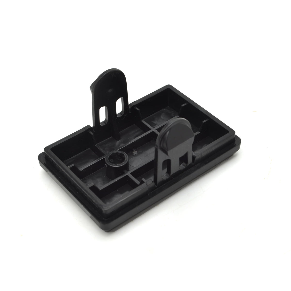Black plastic component on a white background