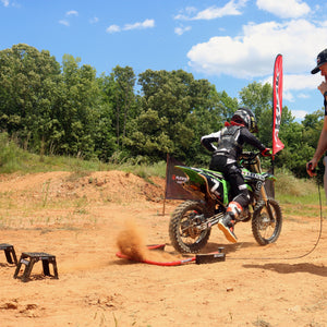 Youth MX ride practicing his starts with his dad. They are using the Holeshot Manual Start Gate from Risk Racing.