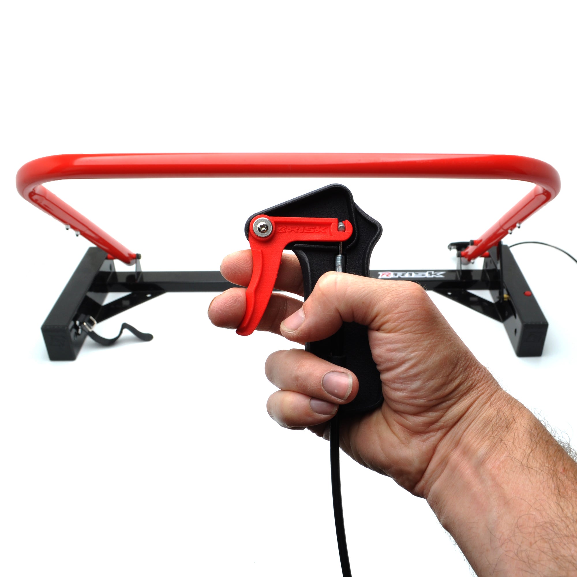 Holeshot Starting Gate Manual Version on a white studio background with a hand holding the trigger mechanism