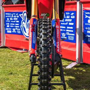 Close up of a motocross bike perfectly straight on and the front tire is a MX2 Matterly GP by Plews Tyres.