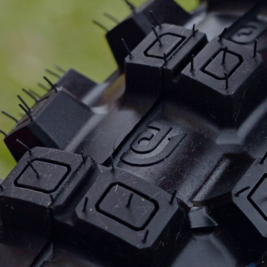 Macro extreme close up of the tire treads of a FOXHILLS GP motocross tire by Plews Tyres brought to you by Risk Racing