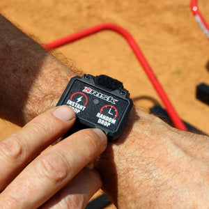 male wrist wearing the wireless remote control for the Holeshot Pro gate in the background