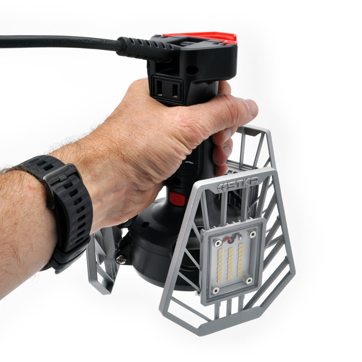 offscreen arm reaching in holding up the TRiLIGHT Shoplight v2 in an upside down hanging position with the LED panels closed